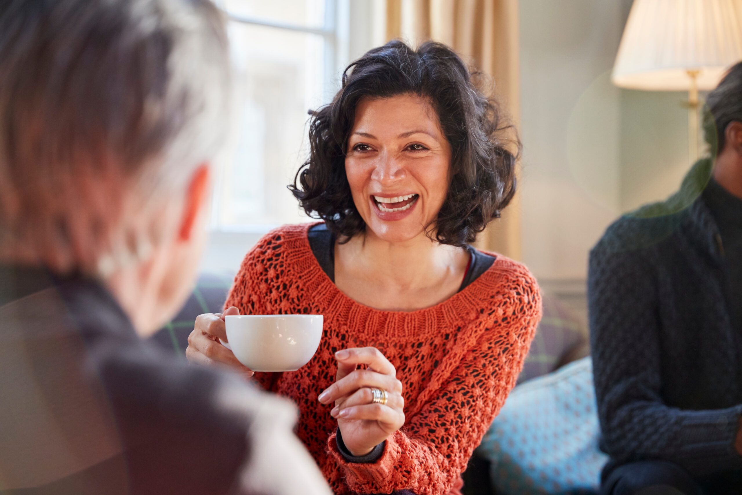 woman smiles with tea cup