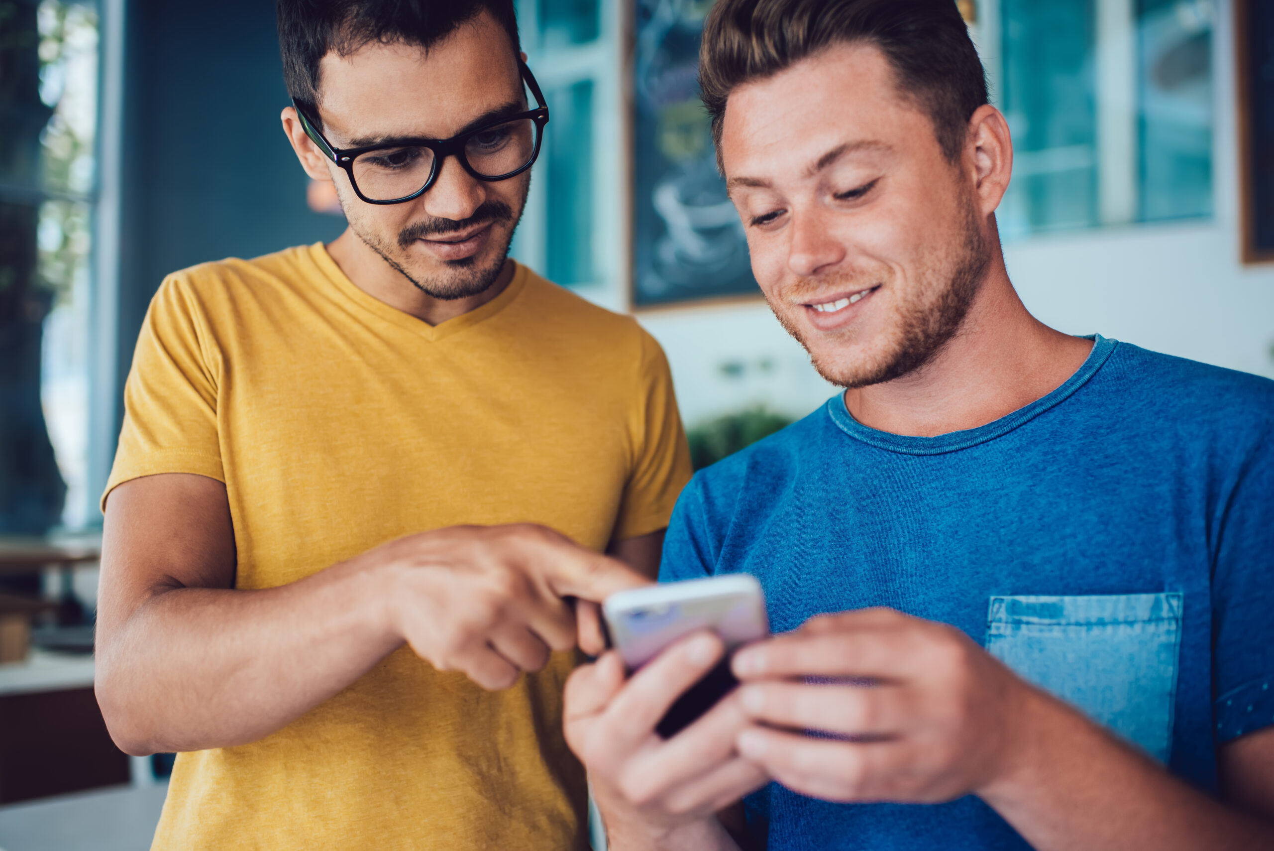 two men looking at phone